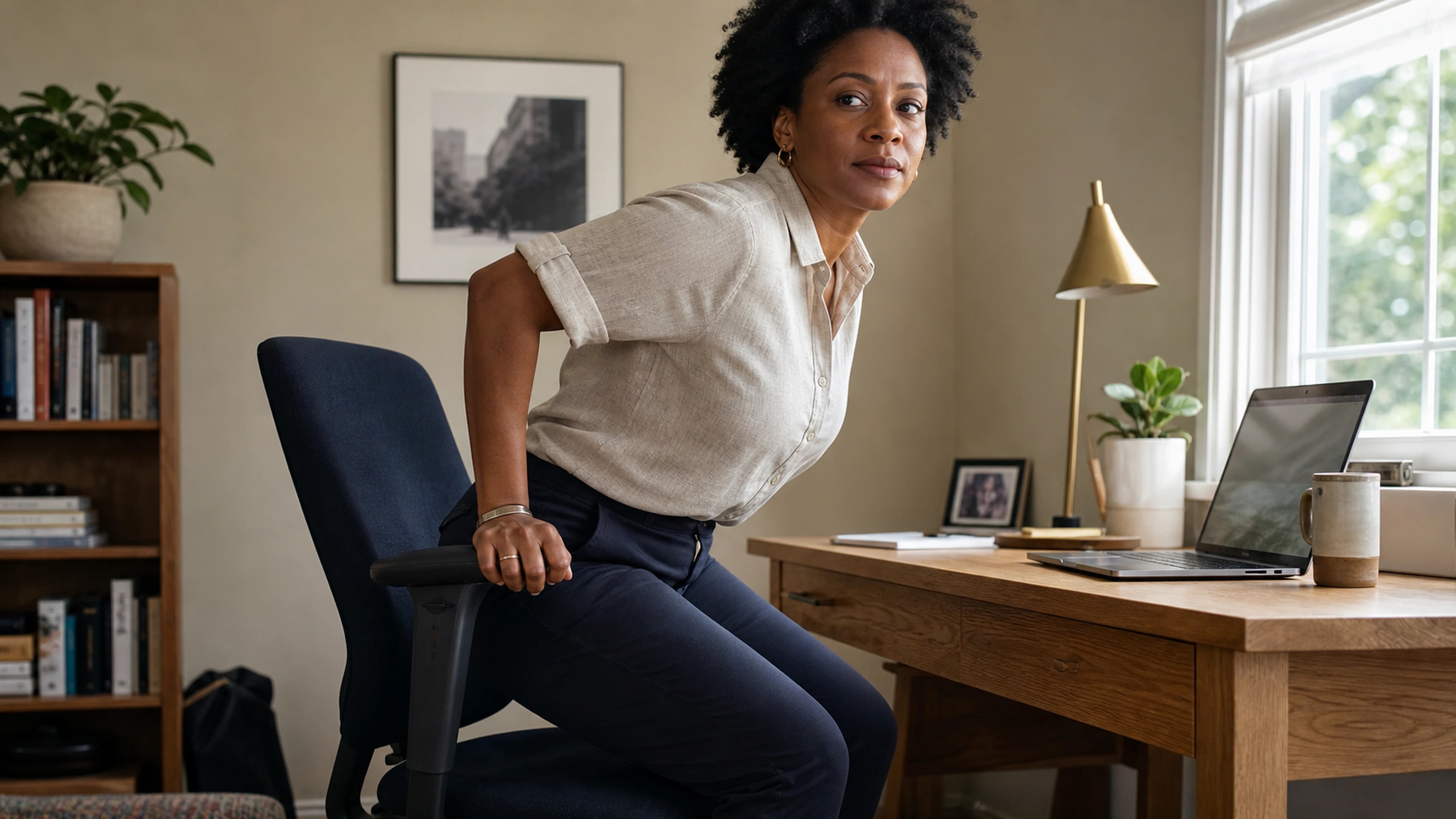 Desk worker comparing seated comfort and chair fit in a calm home workspace