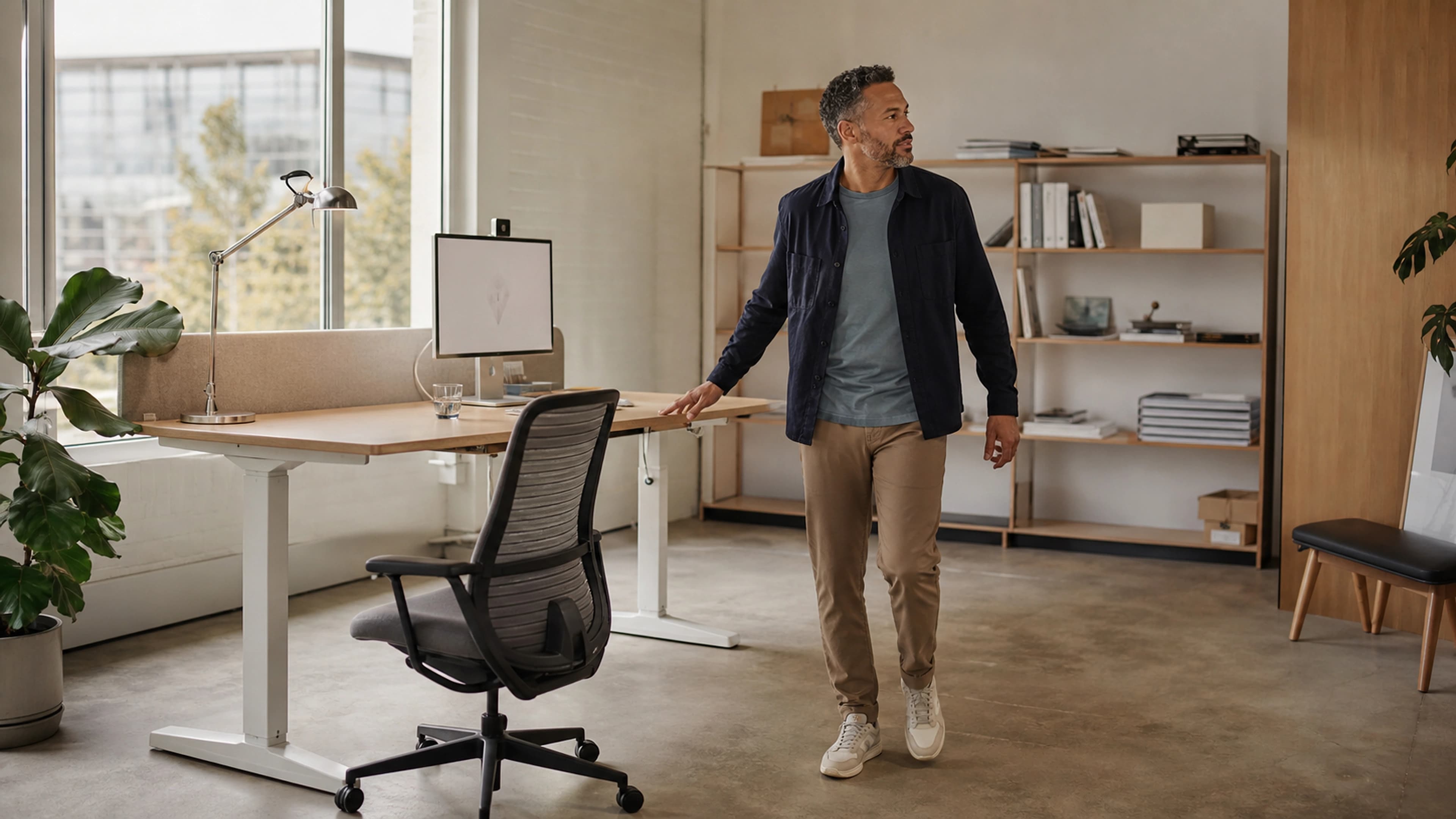 Desk worker easing into a balanced standing position after moving up from their chair