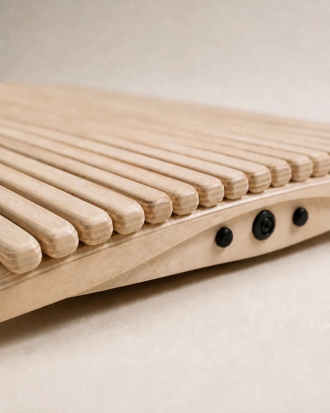 Close-up of rounded wooden slats and three black side fasteners