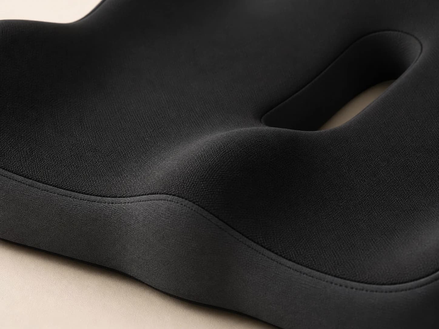 Close-up of the SeatNest black exterior, stitched seam, and sculpted edge