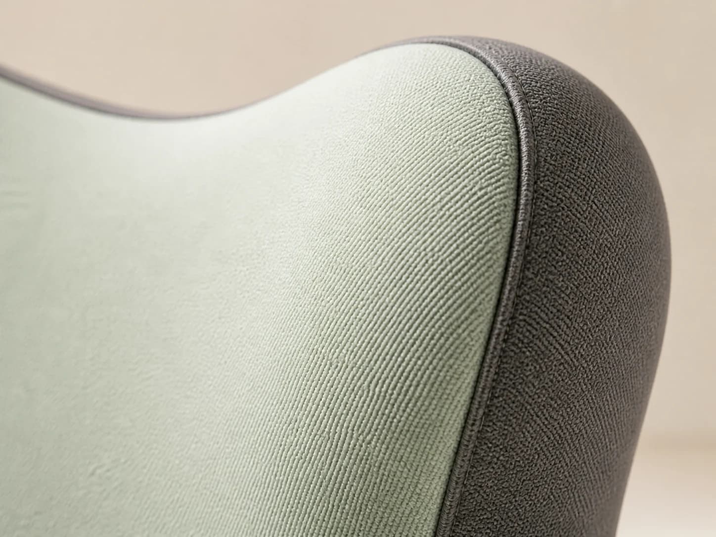 Macro view of the LumaWing gray-green exterior, charcoal side panel, and seam