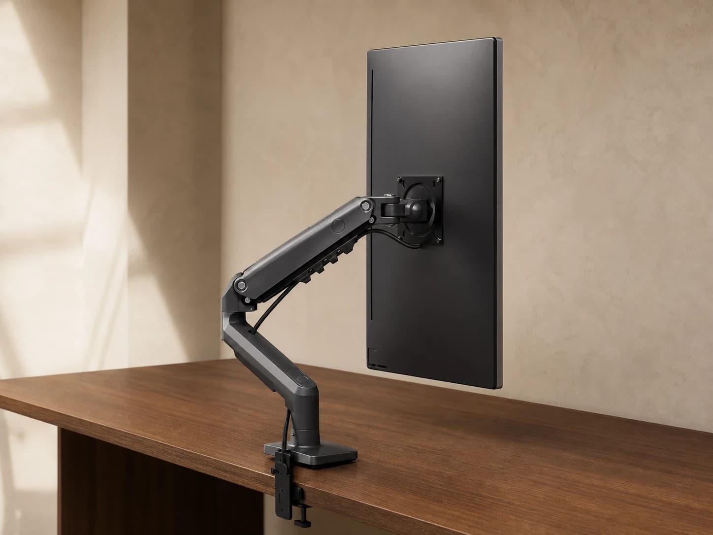 Single monitor in portrait orientation on the black ViewGlide arm and desk clamp