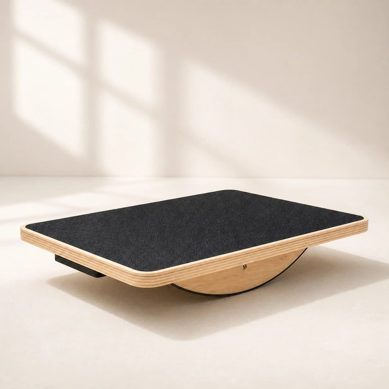PivotArc rectangular black-top balance board on a warm ivory studio set