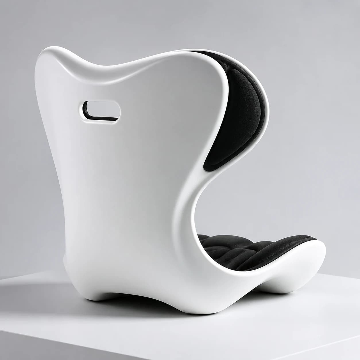 Front three-quarter studio view of the PostureShell winged back, white waist, and sculpted black seat