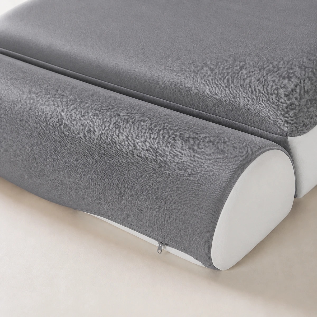 Close-up of the CloudArc matte Ink Grey fabric, white side panel, concealed zipper, and shaped foam