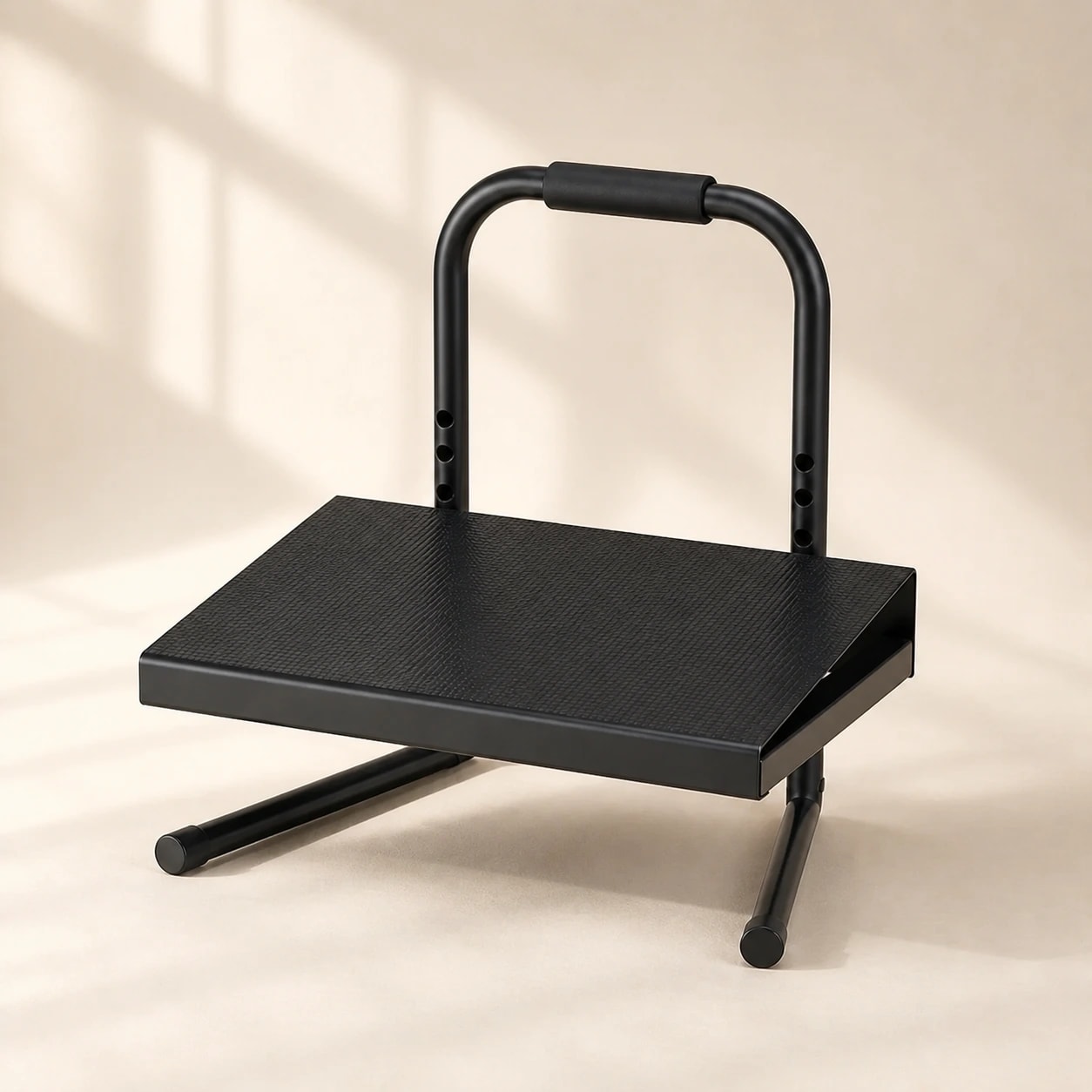 RiseRest 6 black steel six-level footrest on a warm light studio background