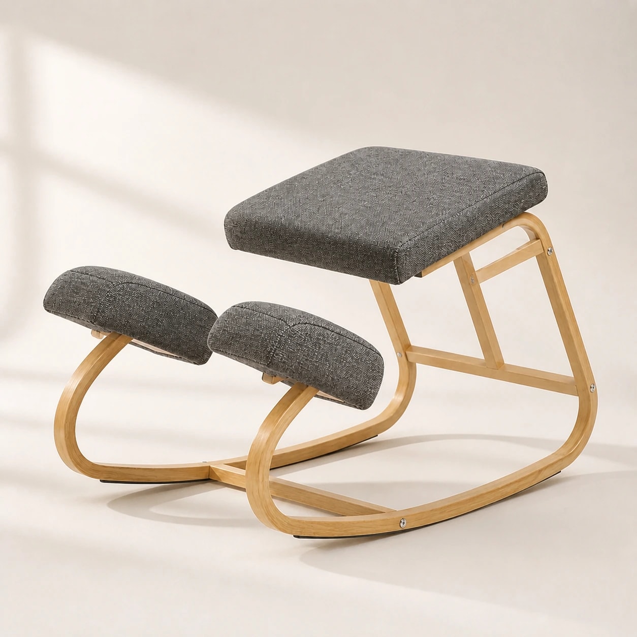 Front three-quarter studio view of the gray backless KneelArc Chair