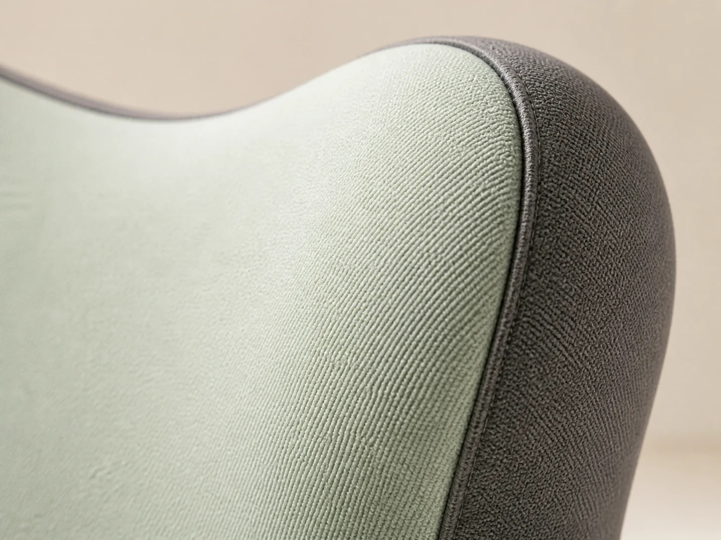 Macro view of the LumaWing gray-green exterior, charcoal side panel, and seam