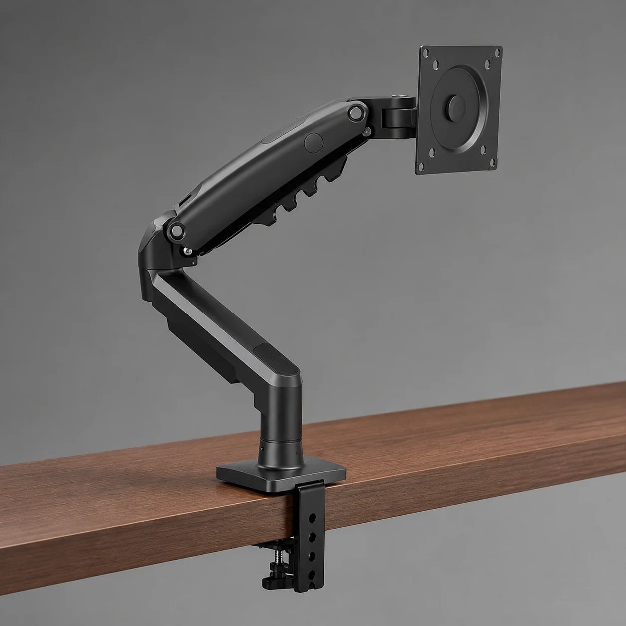 Rear three-quarter studio view of a monitor on the ViewGlide arm with both links, joints, post, and clamp visible