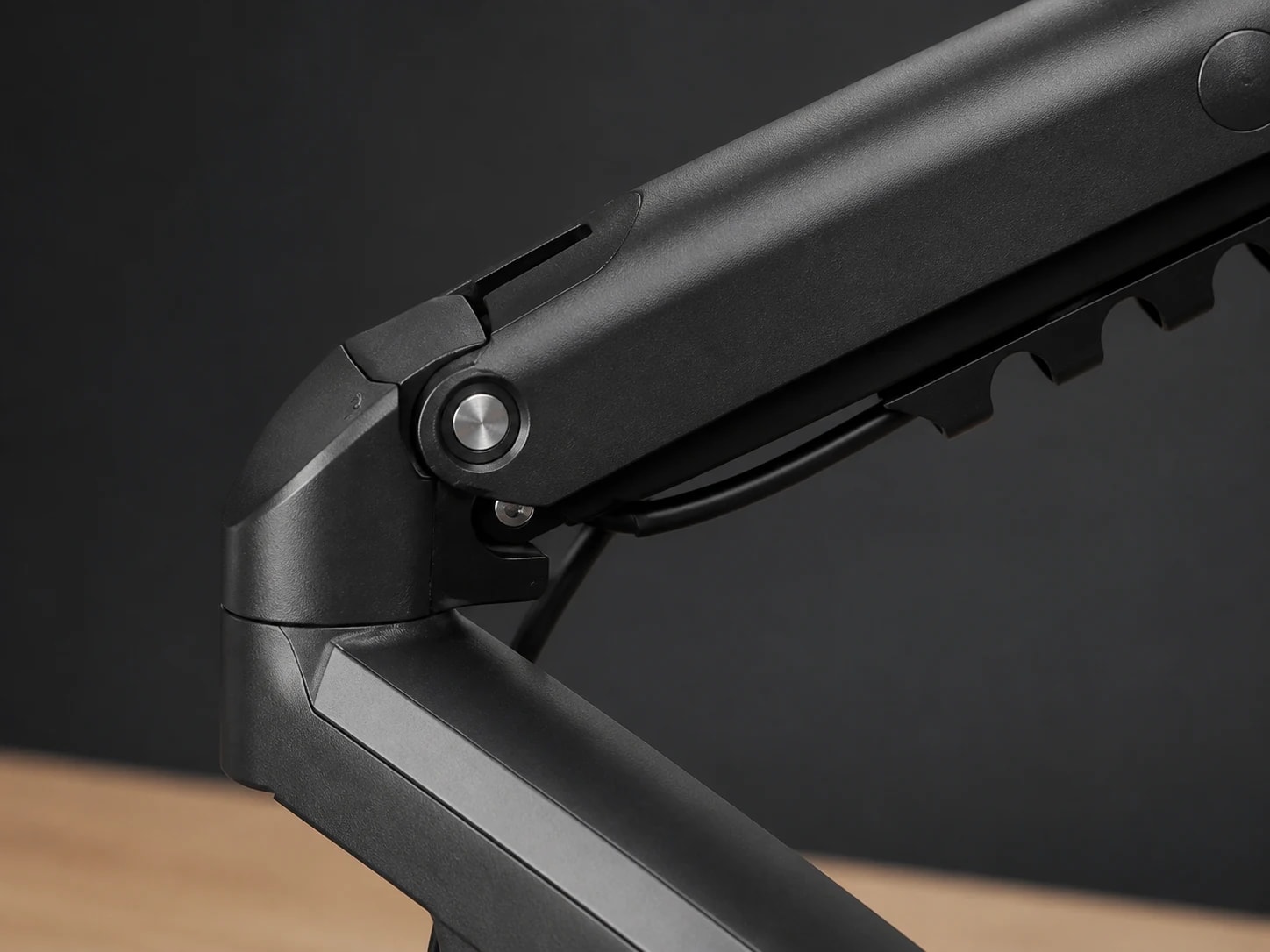 Macro view of the ViewGlide elbow pivot, faceted arm links, and cable path