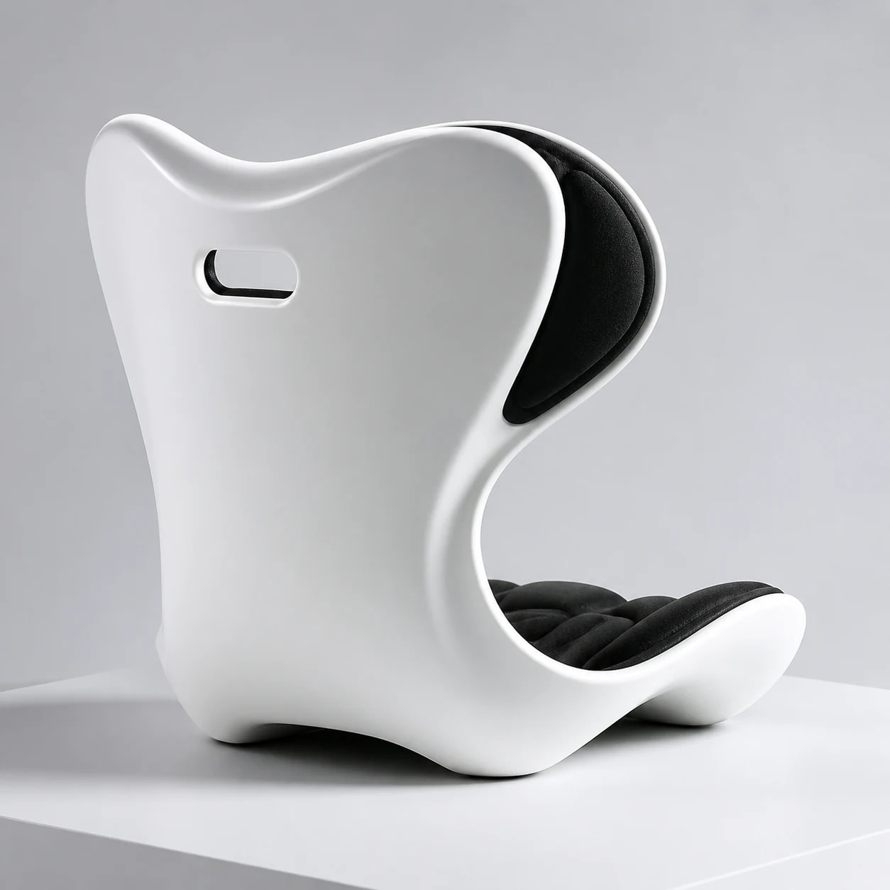 Front three-quarter studio view of the PostureShell winged back, white waist, and sculpted black seat