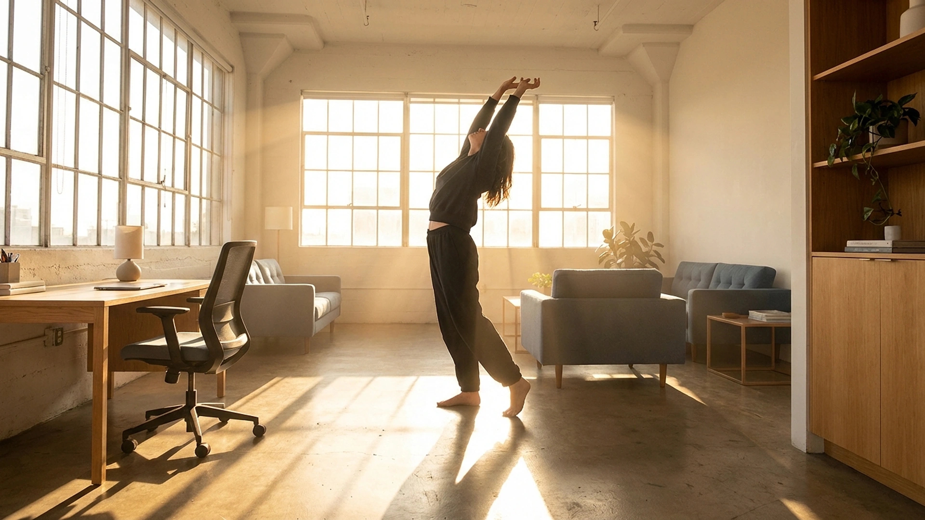 Office worker combining a supported seated setup with a brief standing movement break