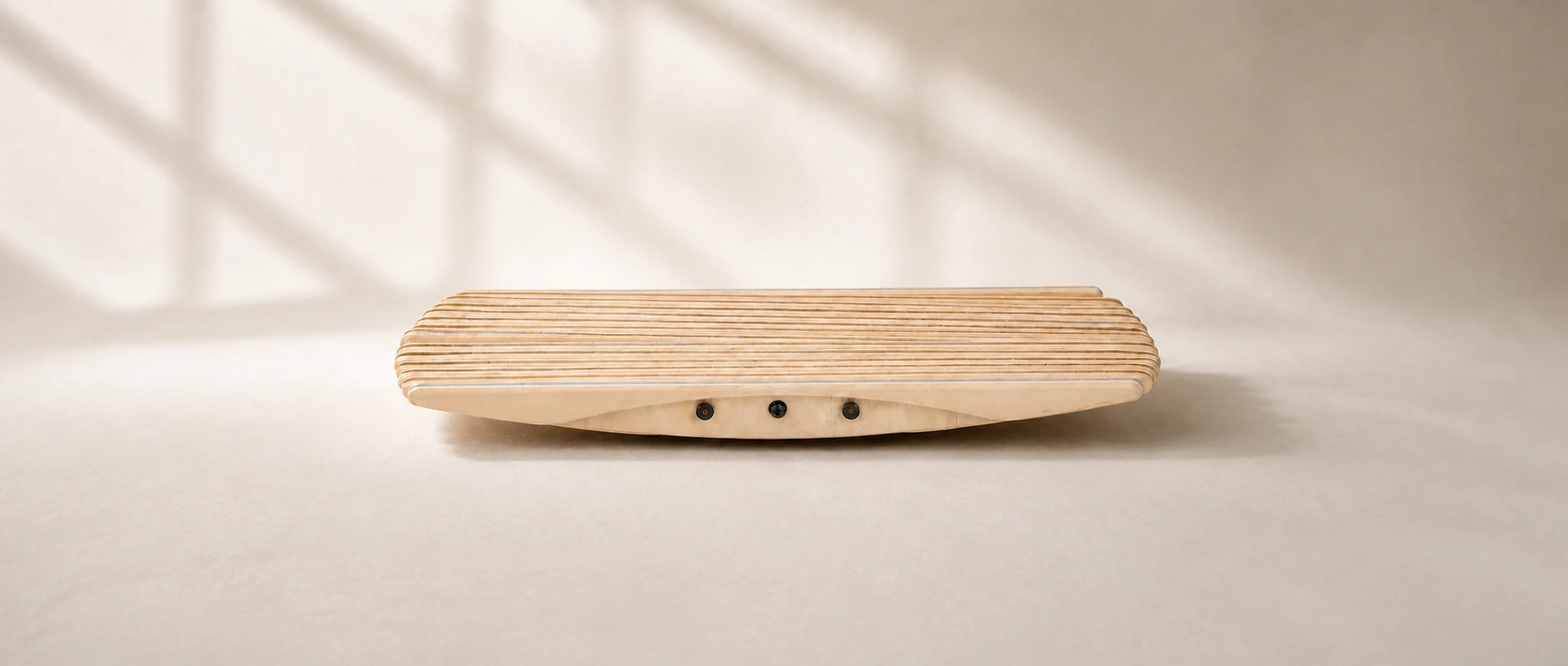 ErgoSway Balance Board showing its curved wooden rocker and ribbed standing deck