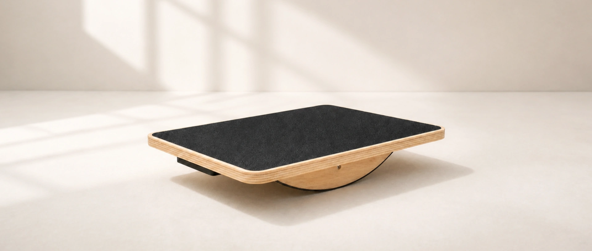 PivotArc Balance Board showing its broad surface and fixed central rocker