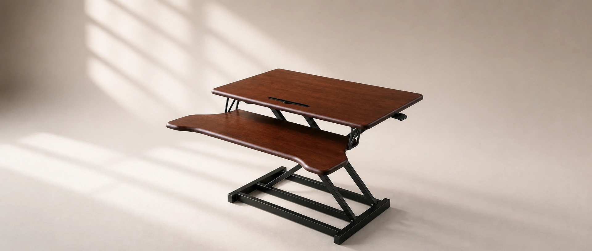 WoodRise Desk Converter showing its wood work surfaces and gas-assisted lift frame